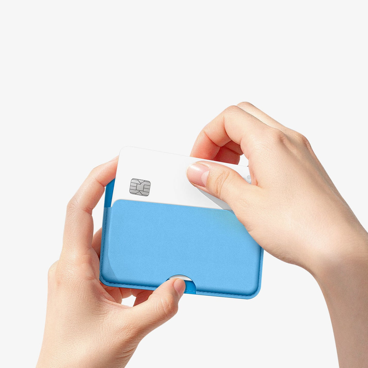 AFA07231 - MagSafe Card Holder Folder Pop (Mag Fit) in Sky Blue showing a person holding the card holder while pulling out the card inside