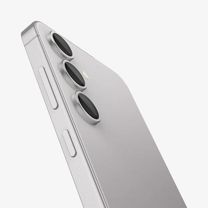 AGL07613 - Galaxy S24 Plus Optik Pro EZ Fit Lens Protector in Marble Gray showing the partial side of the camera lens protector, partial side and partial back of the device, half bodied, zoomed in