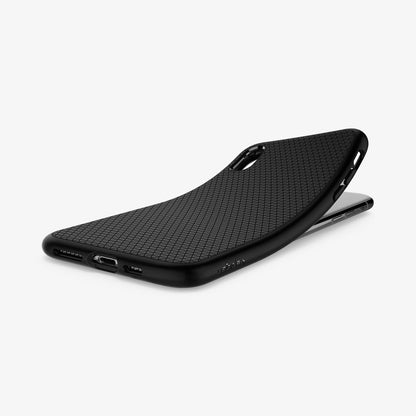 065CS25126 - iPhone XS Max Case Liquid Air in Matte Black showing the back, partially peeled from behind a device on a flat surface