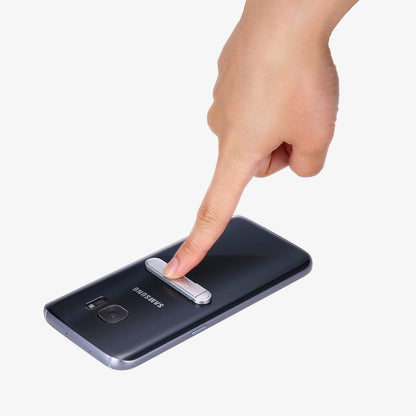 000EM20634 - U100 Universal Kickstand (Metal) in silver showing a finger pushing down on kickstand attached to phone